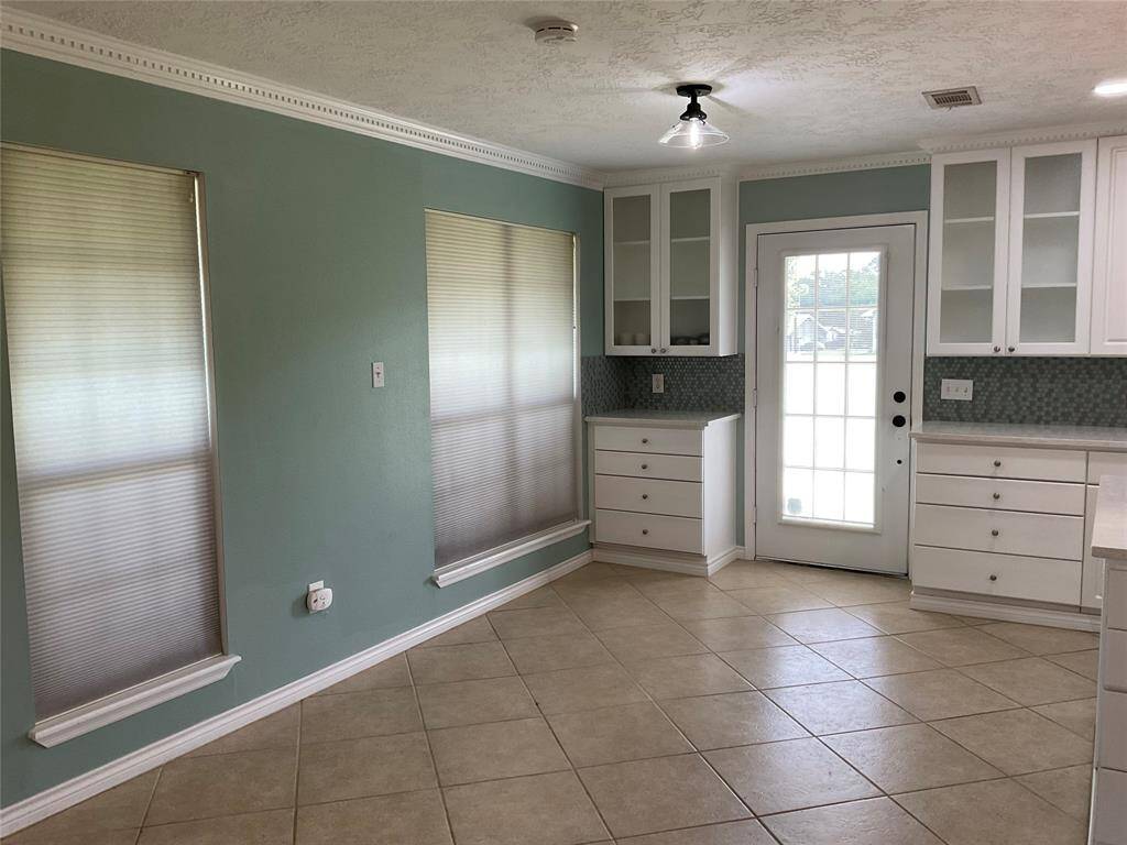 Dining area with more cabinets and new lighting.