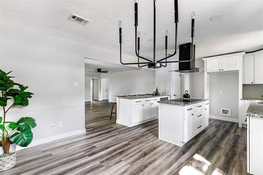 Breakfast area with view into kitchen and family room.