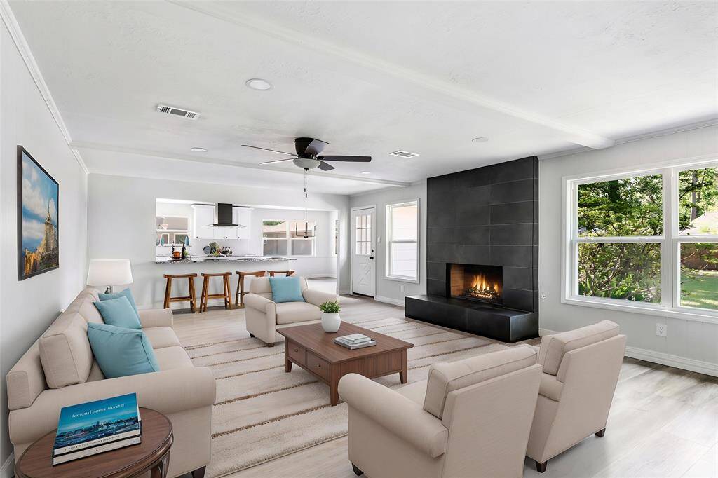 Family room with view into kitchen. This photo has been virtually staged.
