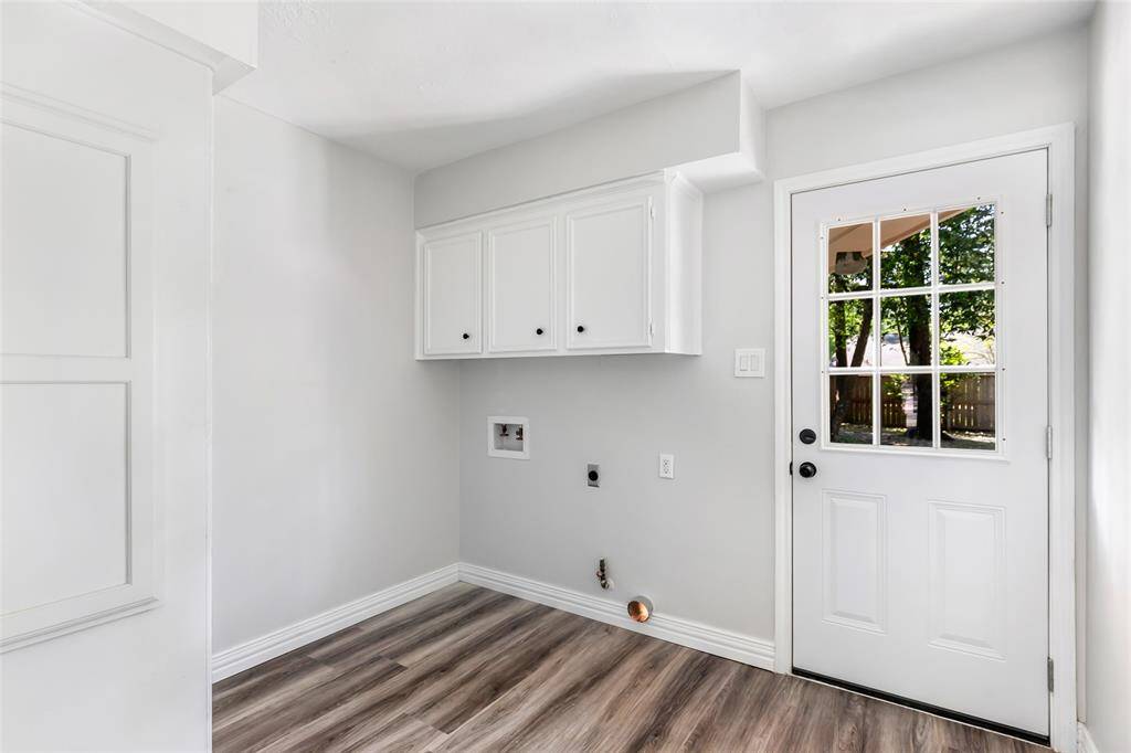 Laundry room with backyard access and half bath.