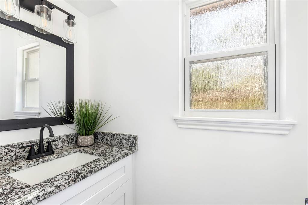 Half bath is located near the back door off the laundry room.