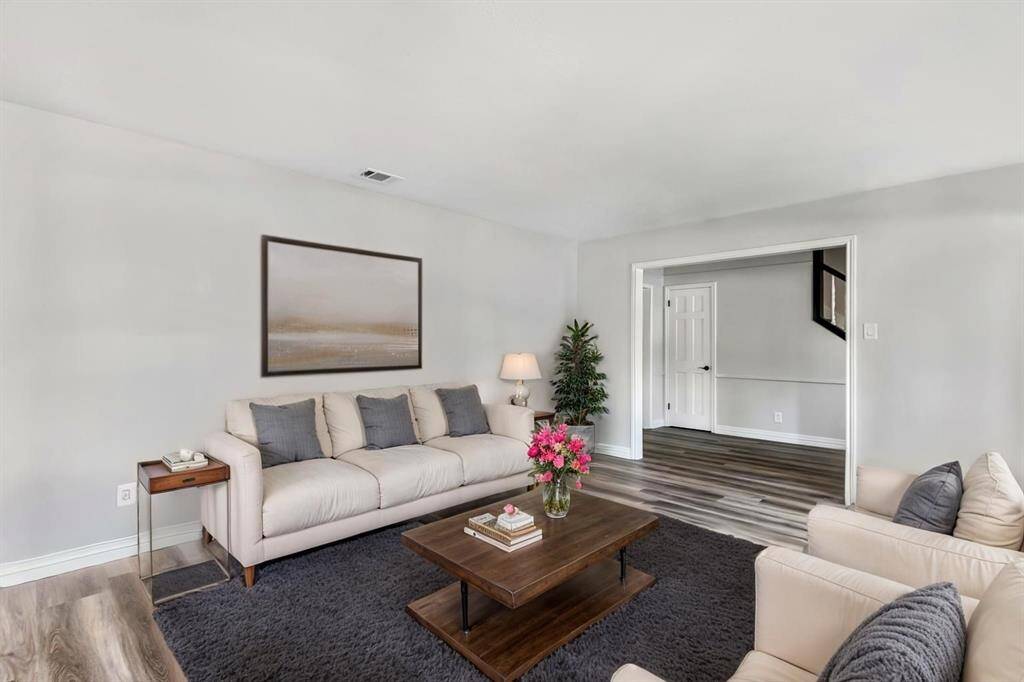 Formal living with view into entry. This photo has been virtually staged.