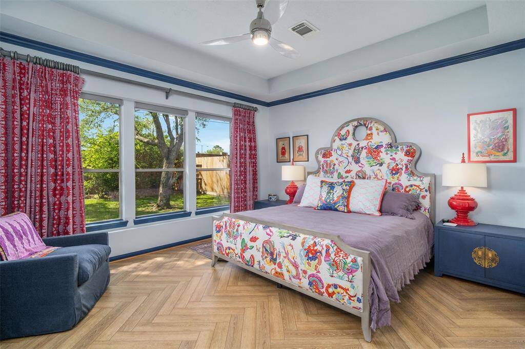 SPACIOUS primary suite with more natural lighting. As you can see, the new flooring continues. A tray ceiling also compliments this room.
