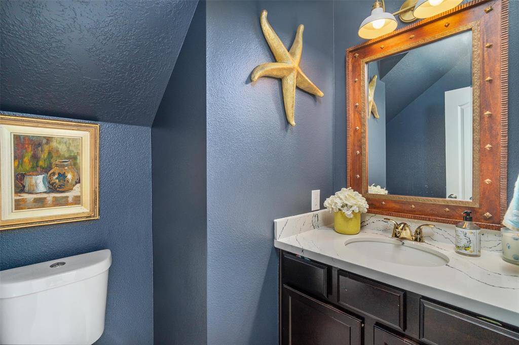 Half bath downstairs also updated with new tile flooring and Cambria Quartz countertops!
