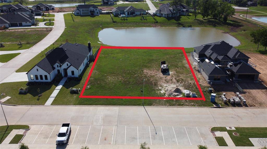 Aerial view of the double lot and pond behind it