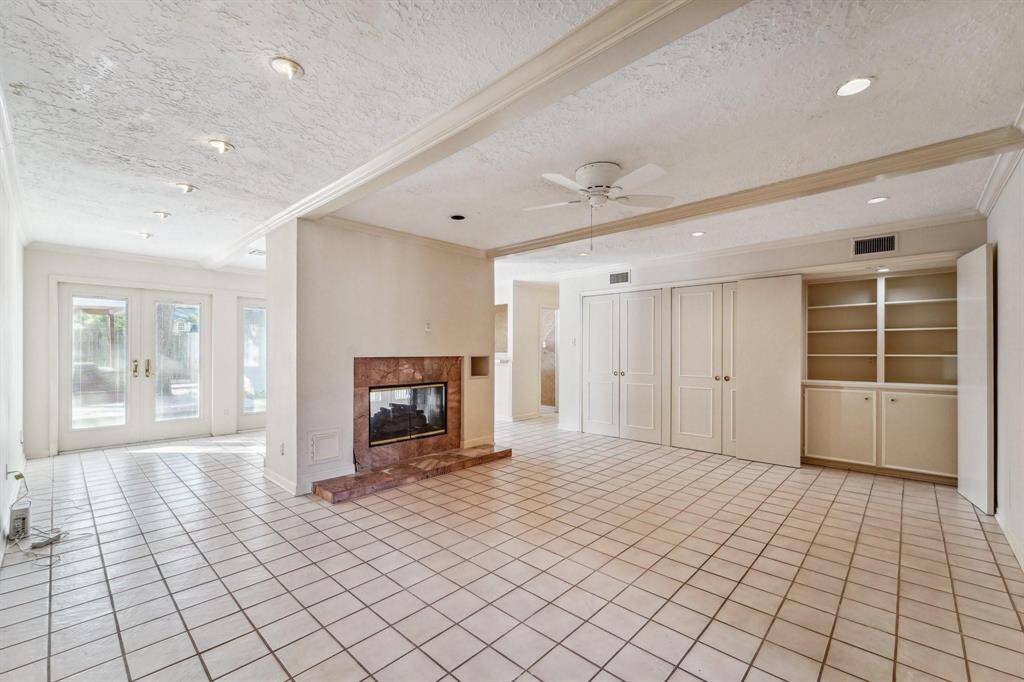 This spacious living area features a cozy double fireplace.