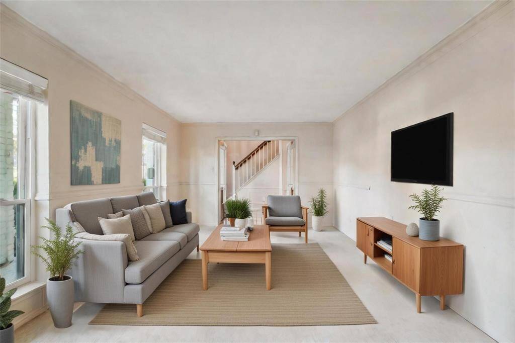 Living area to the right upon entering the home. Virtually staged.