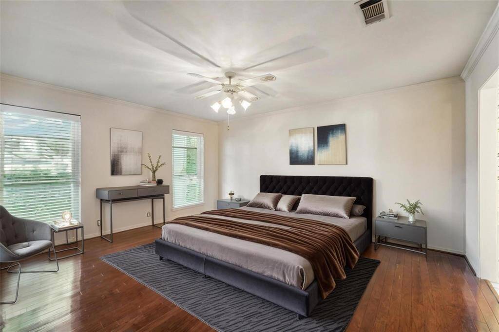 The downstairs Primary bedroom features freshly polished flooring and large windows for natural light. Virtually staged.