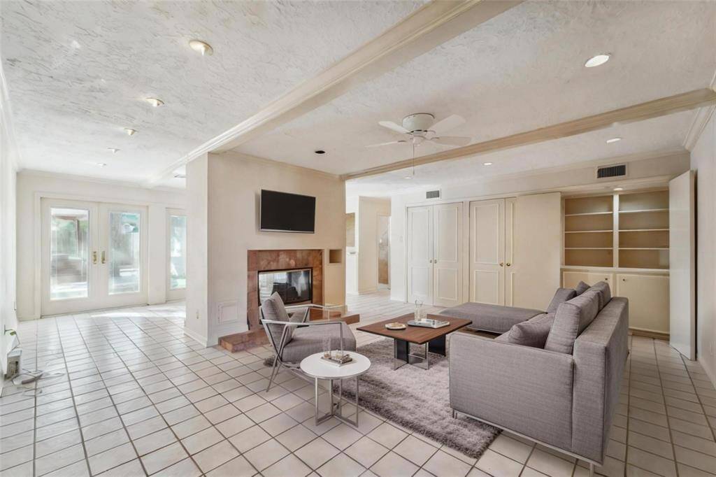 This spacious living area features a cozy double fireplace. Virtually staged.