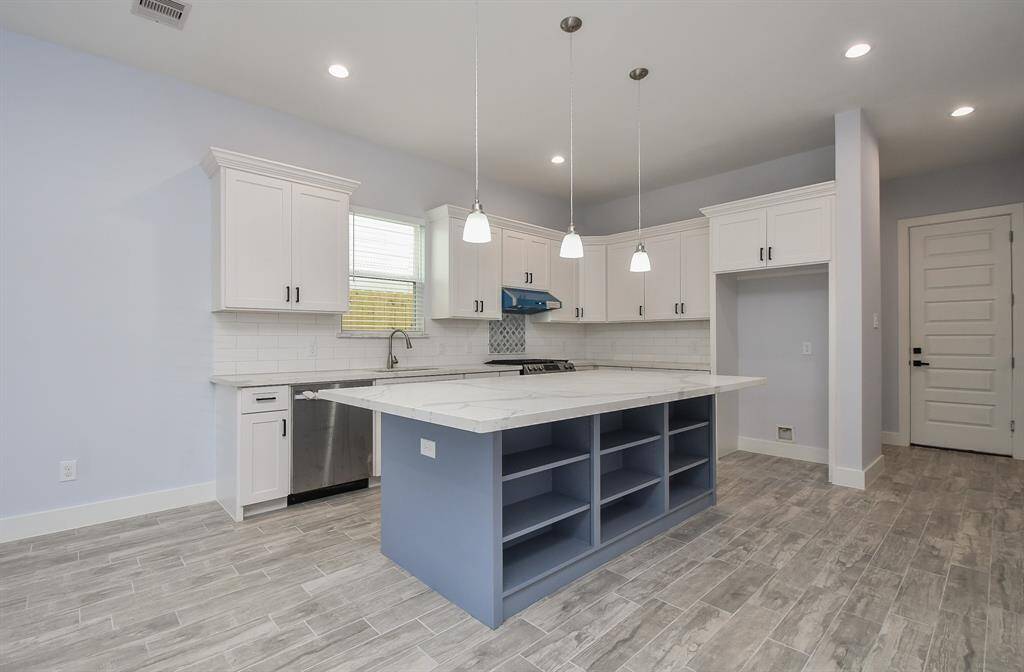 The spacious kitchen, featuring a large island, is ready to inspire the chef of the family.