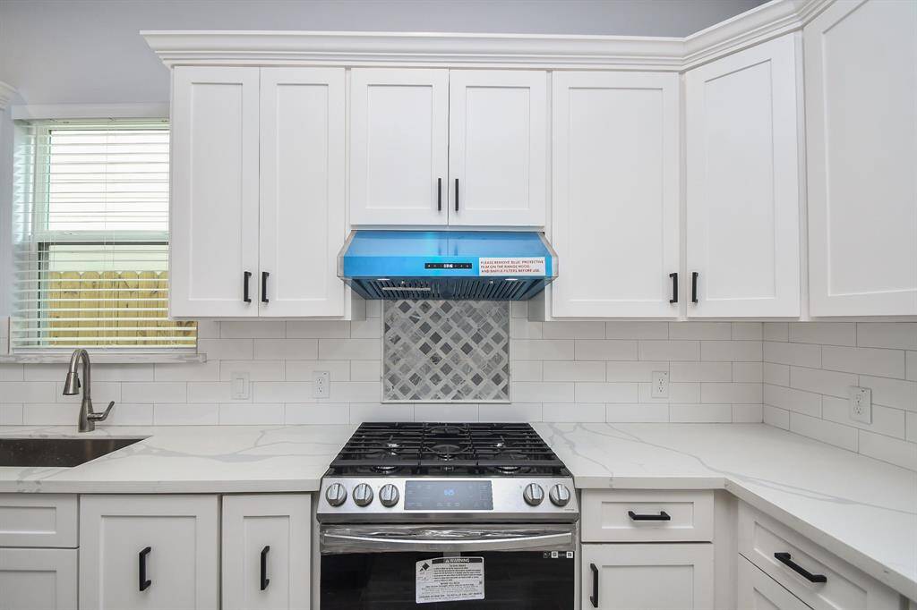 The large window above the sink fills the kitchen with an abundance of natural light.