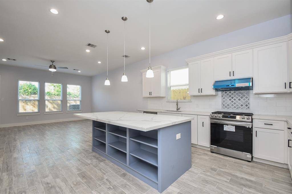 The large kitchen island doubles as a breakfast bar and offers additional storage space.