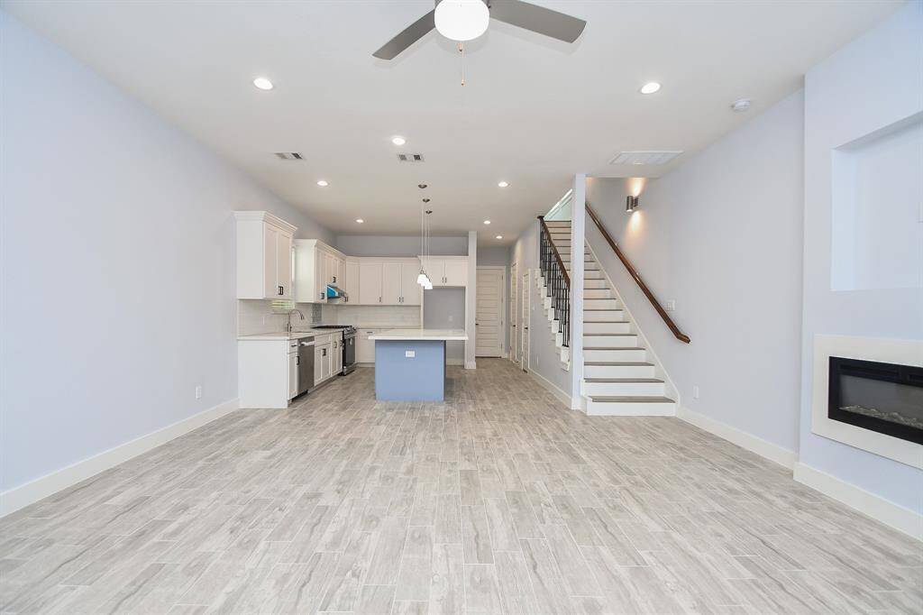 Beautiful recessed lighting highlights the spacious family room, offering plenty of room for your creative ideas, while seamlessly flowing into the kitchen.