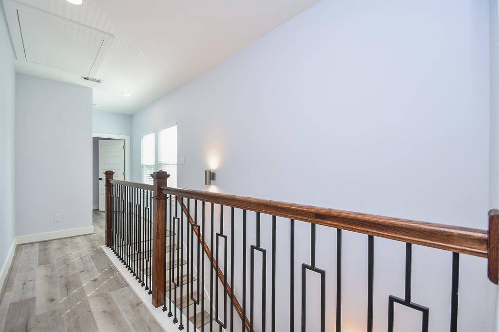 Impressive wood and iron railings add a touch of elegance to the upstairs hallway, enhancing the overall aesthetic.