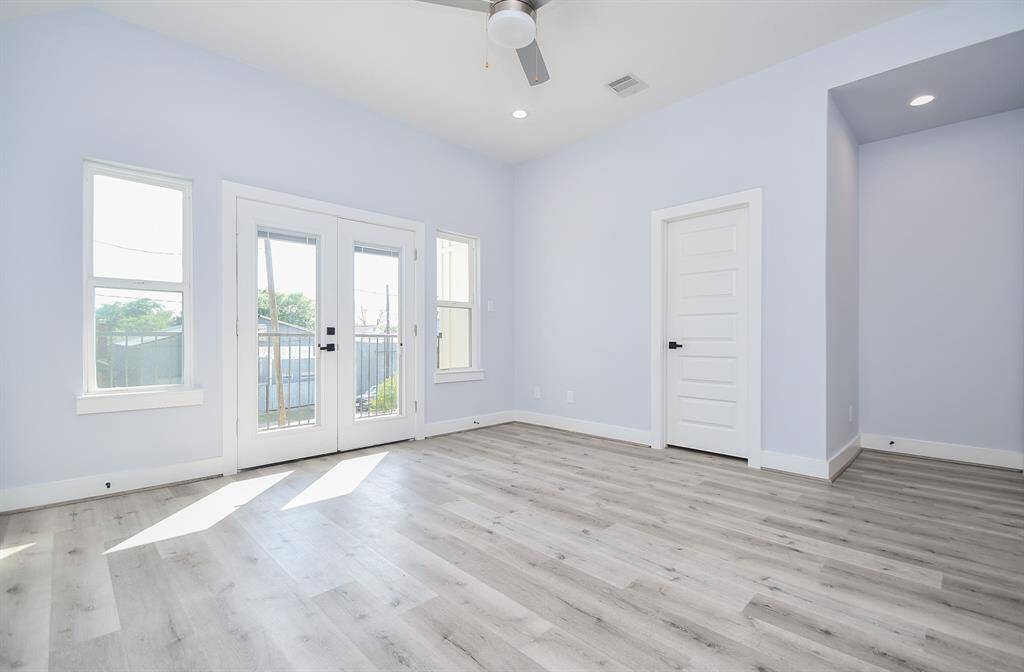 Large windows and double doors to the balcony create a unique primary bedroom experience that effortlessly brings the outdoors in.