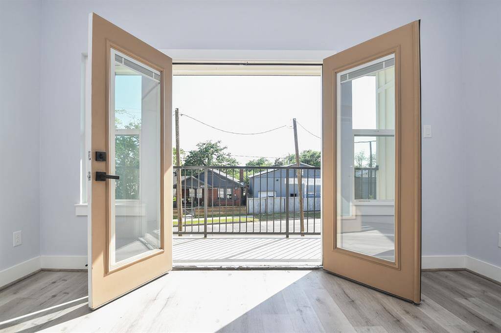 The large glass double doors in the primary bedroom open to reveal your private balcony.