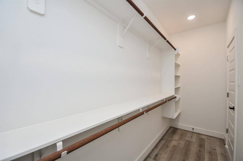 This primary bedroom closet offers plenty of space for all your storage needs.