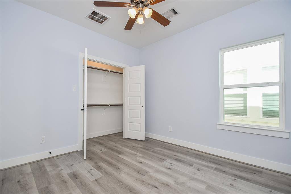 The secondary bedrooms, featuring stylish ceiling fans, also offer ample closet space for storage.