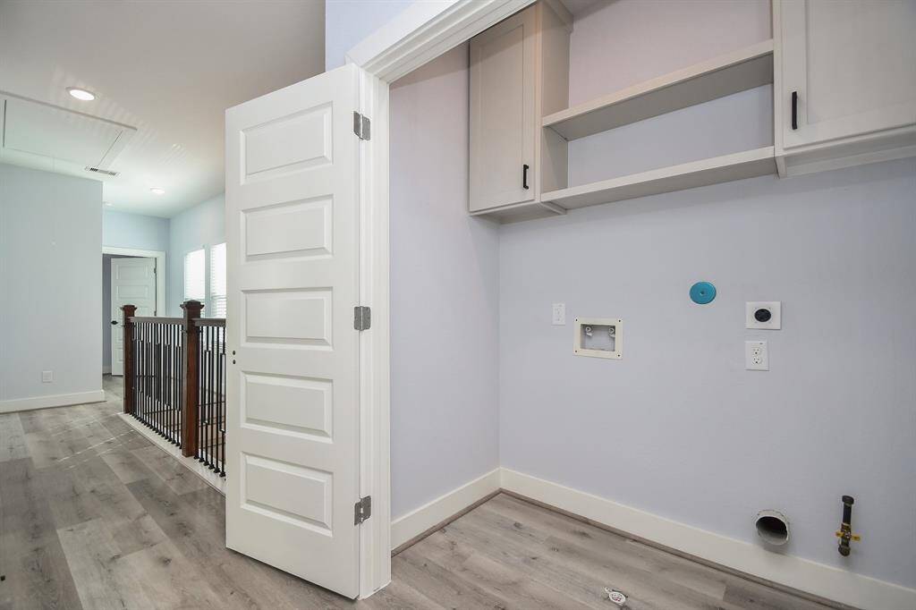 Conveniently located just outside the second-level bedrooms, the spacious laundry area offers ample cabinet space for all your storage needs on wash day.