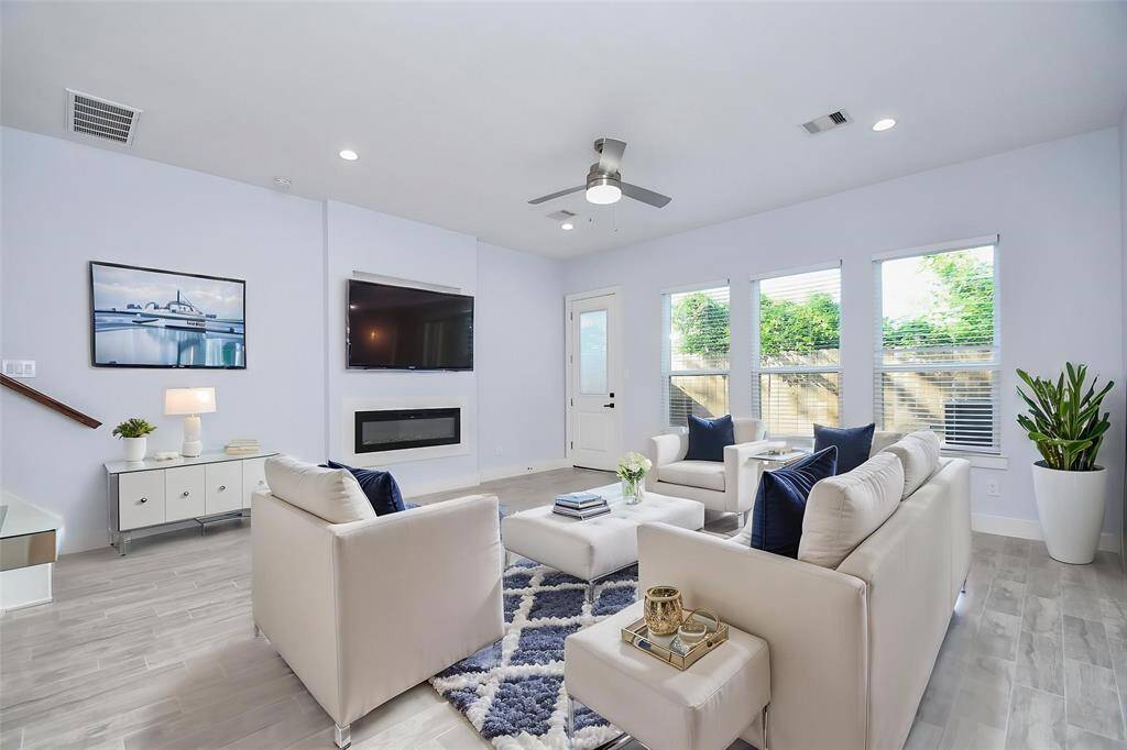 Flooded with natural light from large floor-to-ceiling windows, the family room shines—virtual staging helps you envision the endless possibilities.