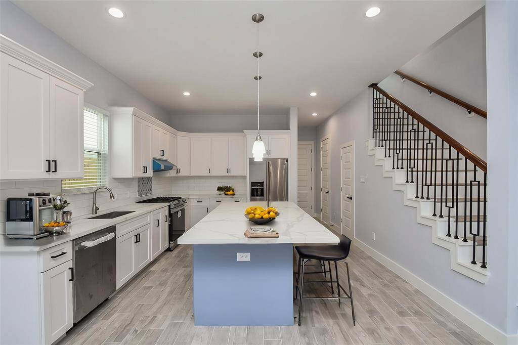 This kitchen offers plenty of workspace with stunning quartz countertops that combine beauty and functionality.