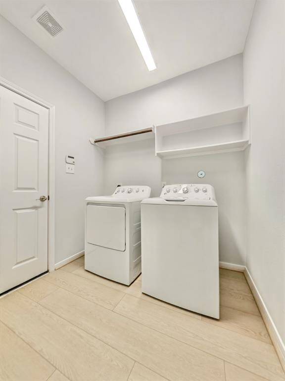 This spacious laundry room, washer and dryer included, ample shelving for storage.