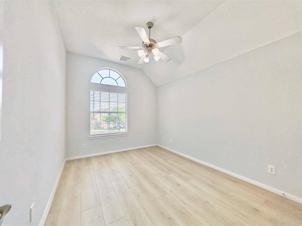 Upstairs 3rd Bedroom with vaulted ceiling and ceiling fan