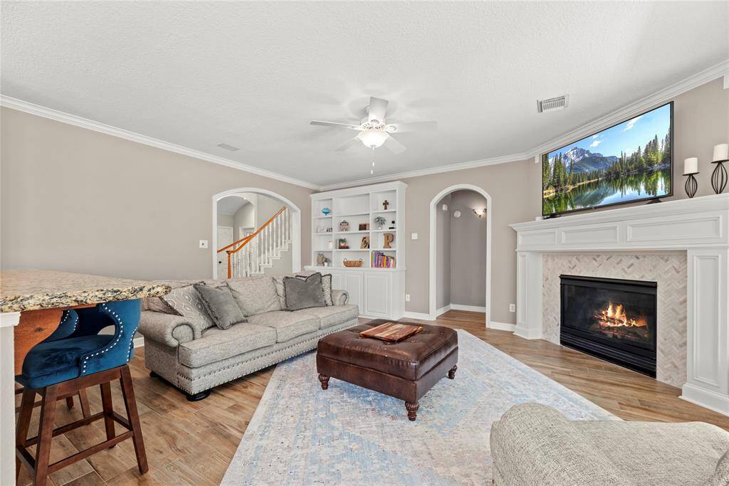 The inviting fireplace becomes a focal point that anchors the room and invites people to gather and linger, making it a cherished feature of the living area.