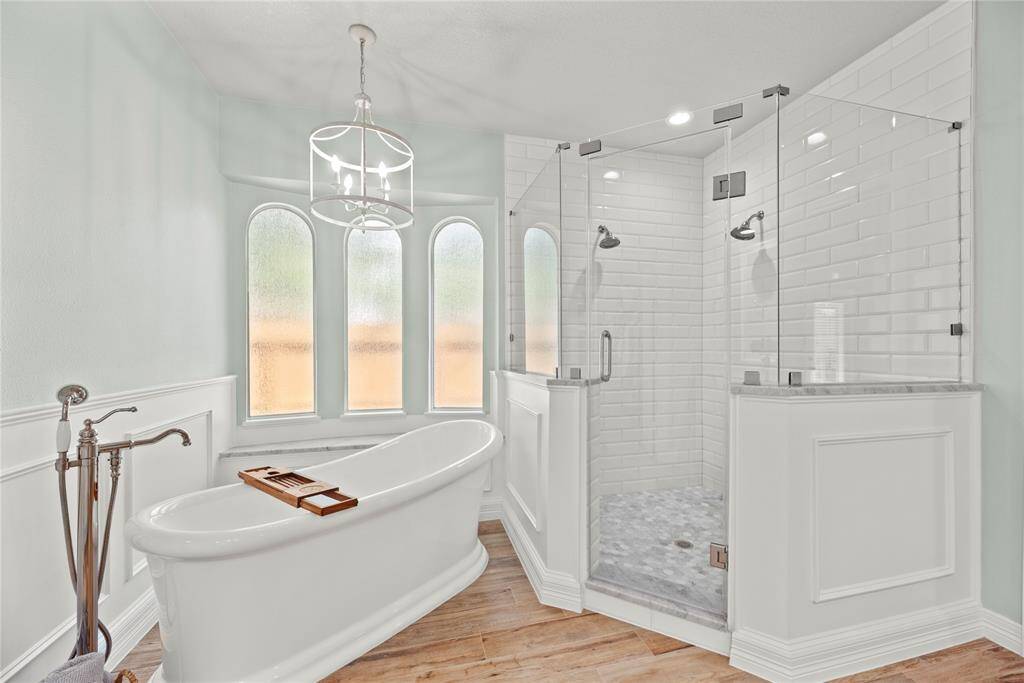 The free standing soaking tub is a perfect space to sink in and relax. The expansive walk-in shower with dual shower sprays, adorned with stunning tile work and a sleek glass front, offers a luxurious escape for a quick rinse or a refreshing retreat.