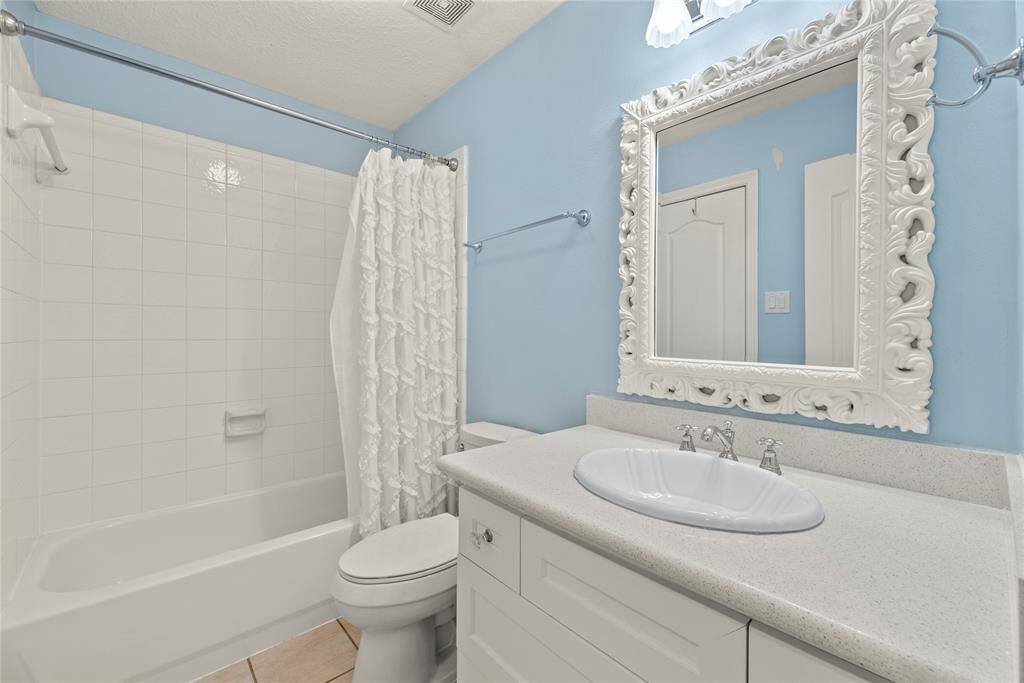 Private bath for the first upstairs secondary bedroom. Bathroom features custom cabinet and quartz countertops!