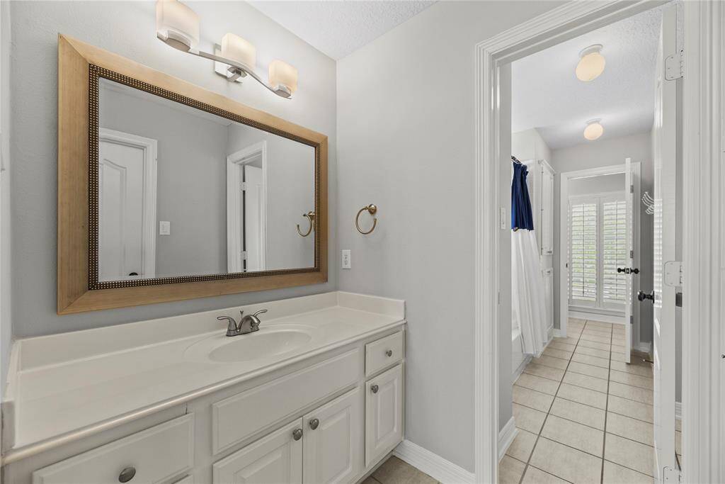 Hollywood bath with updated light fixtures, framed mirrors, and brushed nickel hardware!