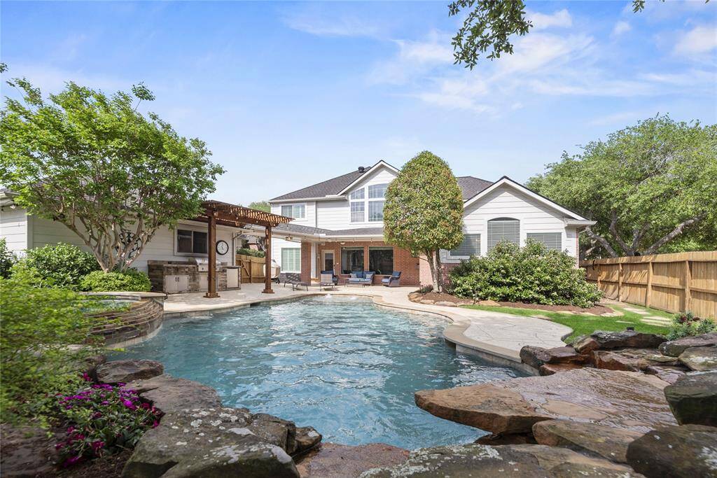 Stunning pool and spa combination with lush landscaping provide the perfect "escape" from the stresses of everyday life.