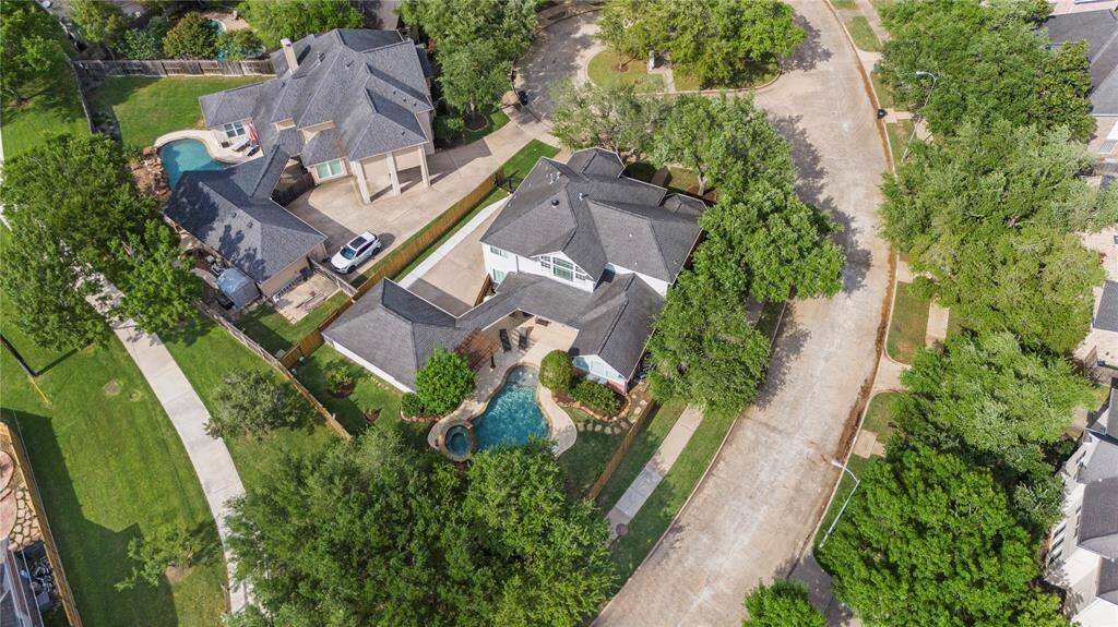 From this aerial view of the back of the home, you can fully appreciate its beauty, elegance, and remarkable charm. This property offers everything a family could wish for and more.