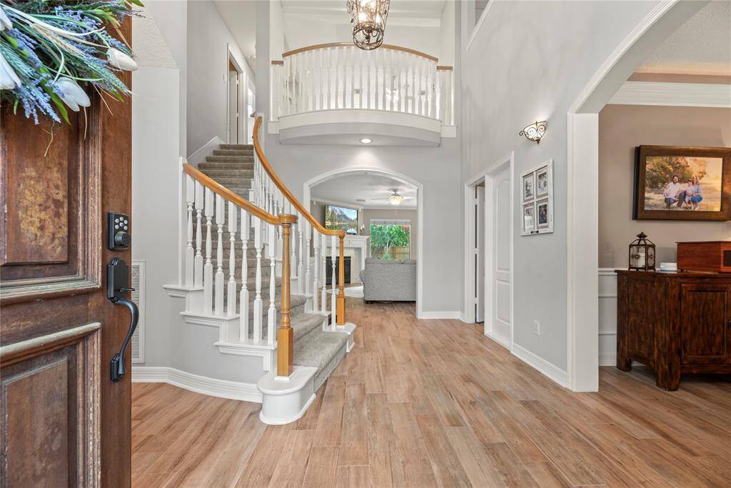 As you walk in, you're warmly greeted by a graceful curved staircase and inviting wood floors that instantly make the space feel like home.