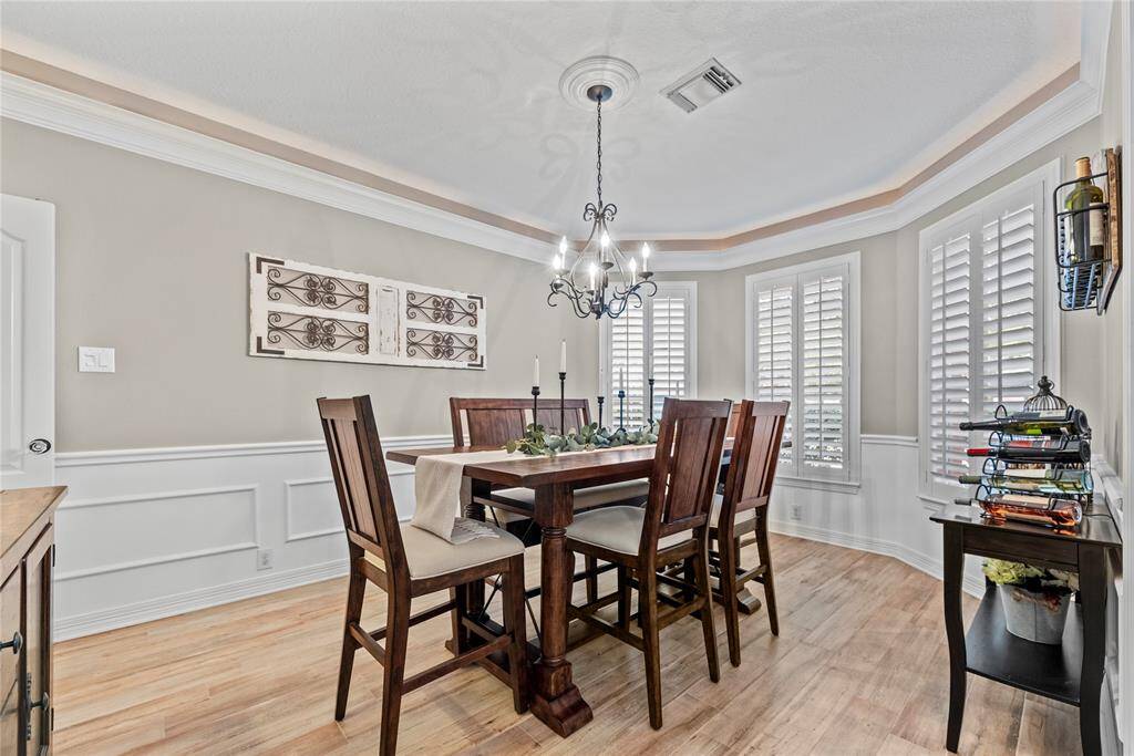 Entertaining in this formal dining space is perfect with the direct access to the kitchen.  Double crown molding, up lighting and custom woodwork give and elegant feel to the room.