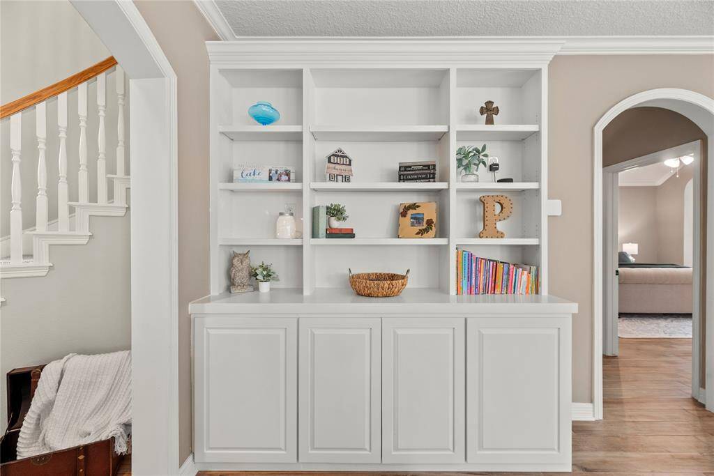 The living area showcases custom built-in cabinetry, blending style and function with thoughtfully designed storage and display space that enhances the room’s charm and character.