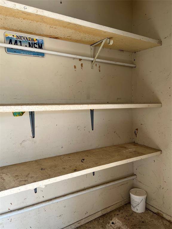 Shelves inside the storage room under carport.