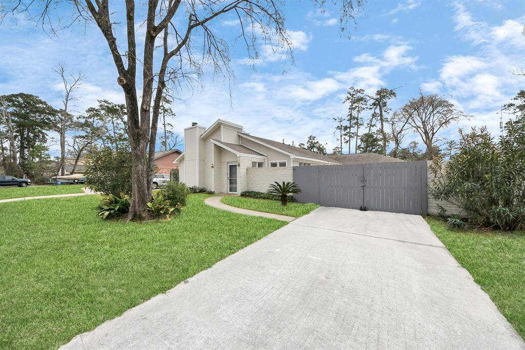 Charming modern home with a sleek design, featuring a spacious driveway and well-maintained lawn. The property is surrounded by lush greenery, offering privacy and a serene atmosphere. Ideal for those seeking a contemporary living space in a peaceful neighborhood.