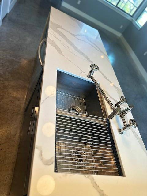 Granite countertops and double bowl stainless steel appliances sink.