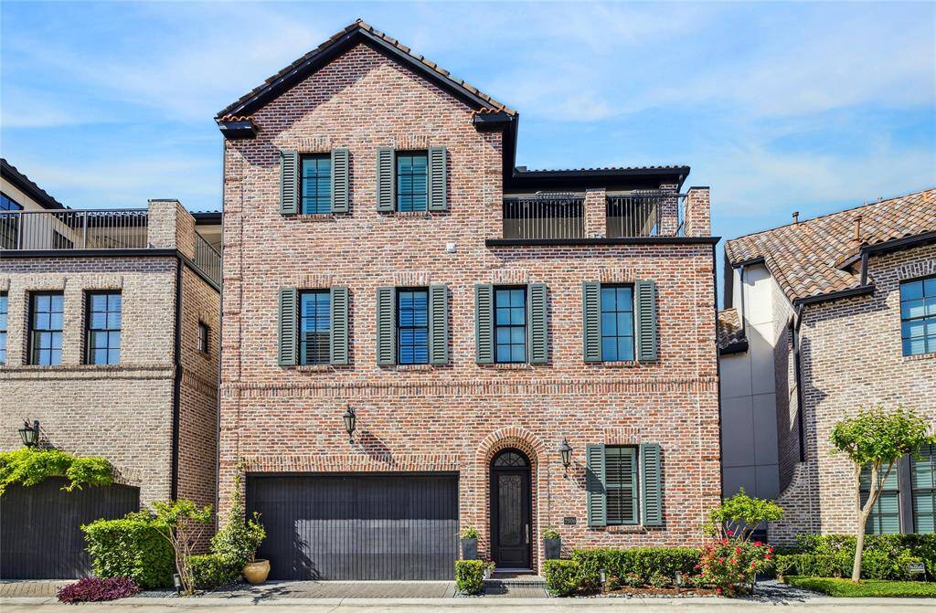 Chic with shutters, this classic brick home has curb appeal that never goes out of style.