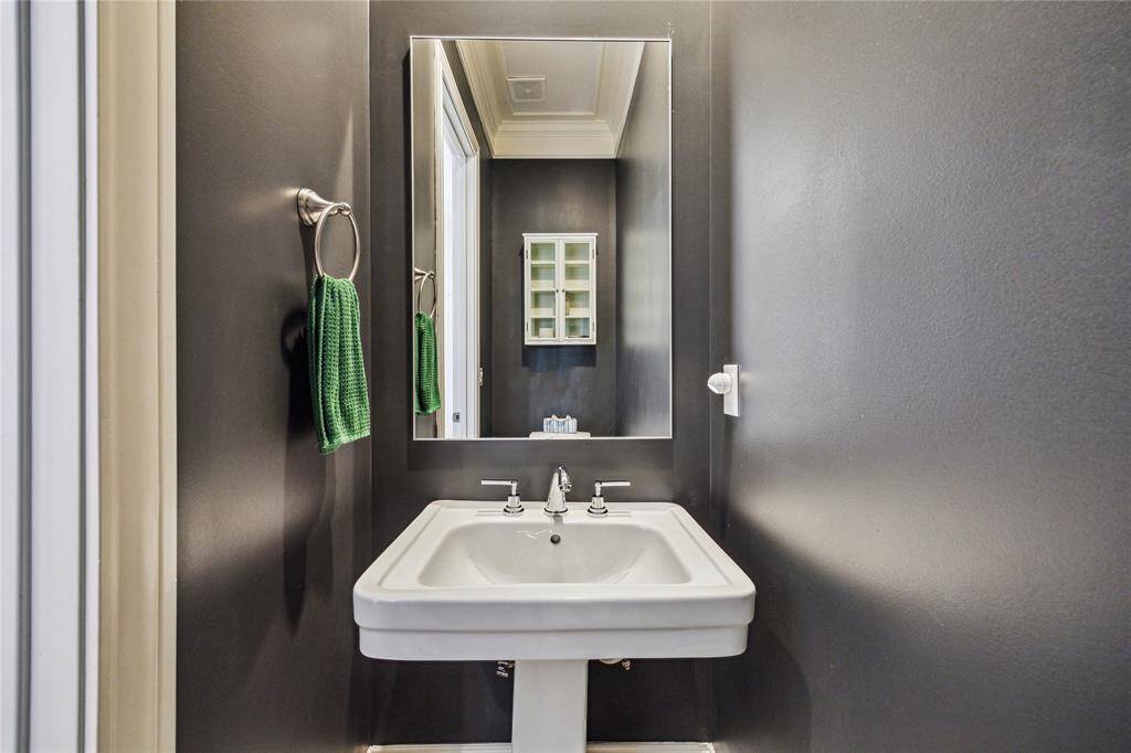 Powder room is out of the way and painted in Iron Ore for a fun surprise.