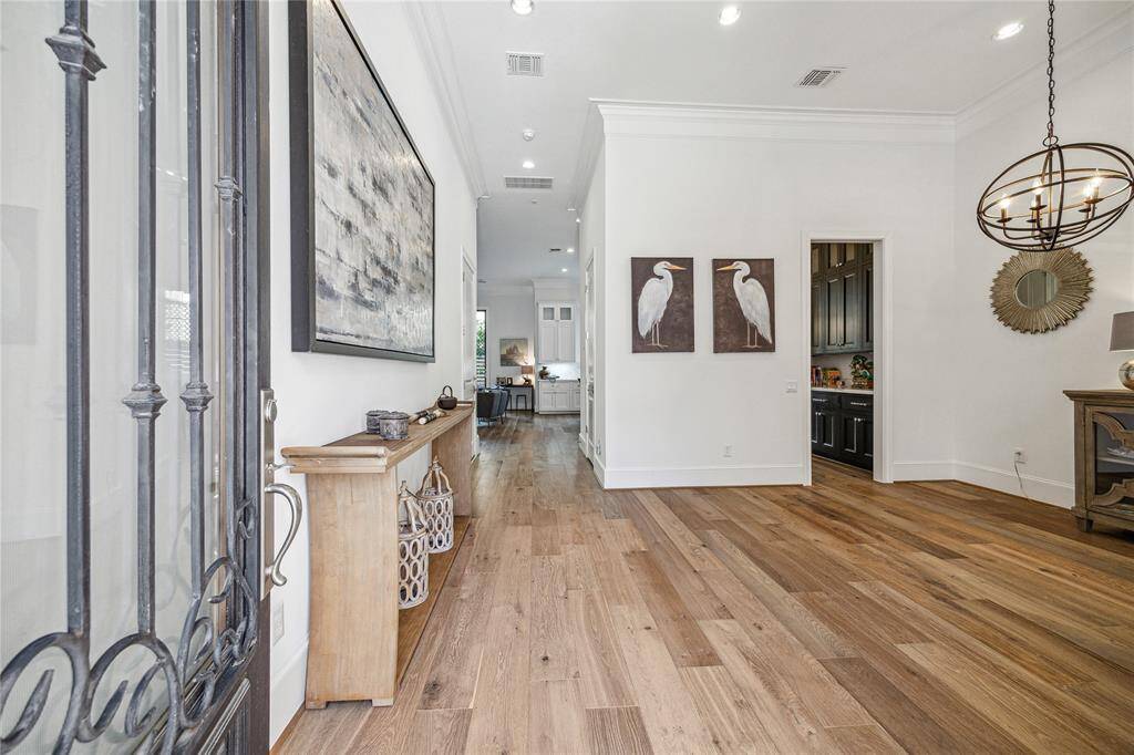 Enter through the glass paneled and wood door with custom iron detail.