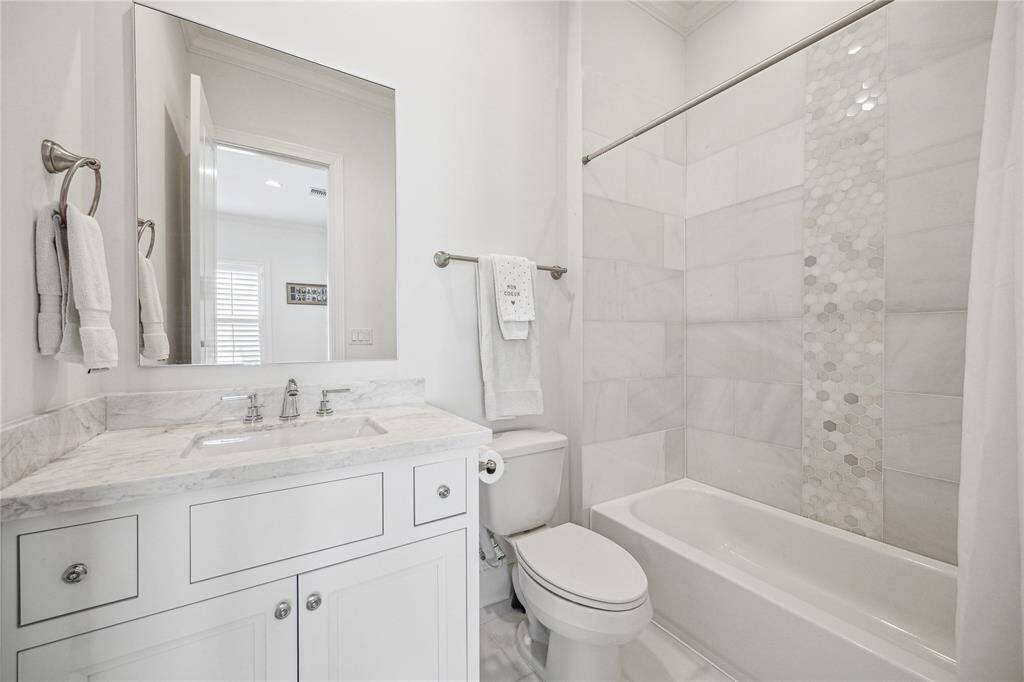 Look at the charming tilework surrounding the tub.