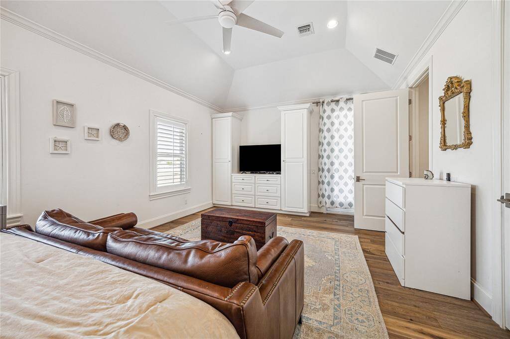 This third-floor secondary bedroom is huge and offers lots of built in cabinetry in addition to its closet.
