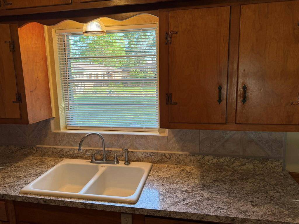 Lovely view out to the backyard  from your kitchen sink.