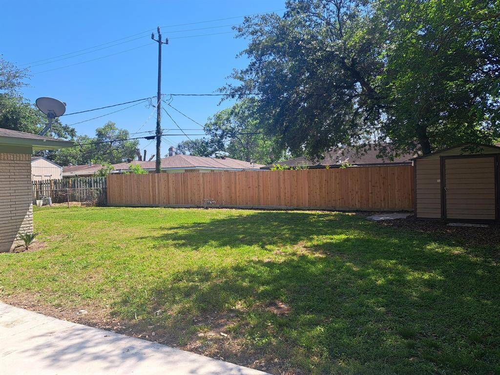 One view of the backyard and storage shed off the patio,