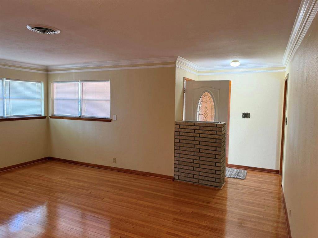 View of the living area from the dining area to the front door.