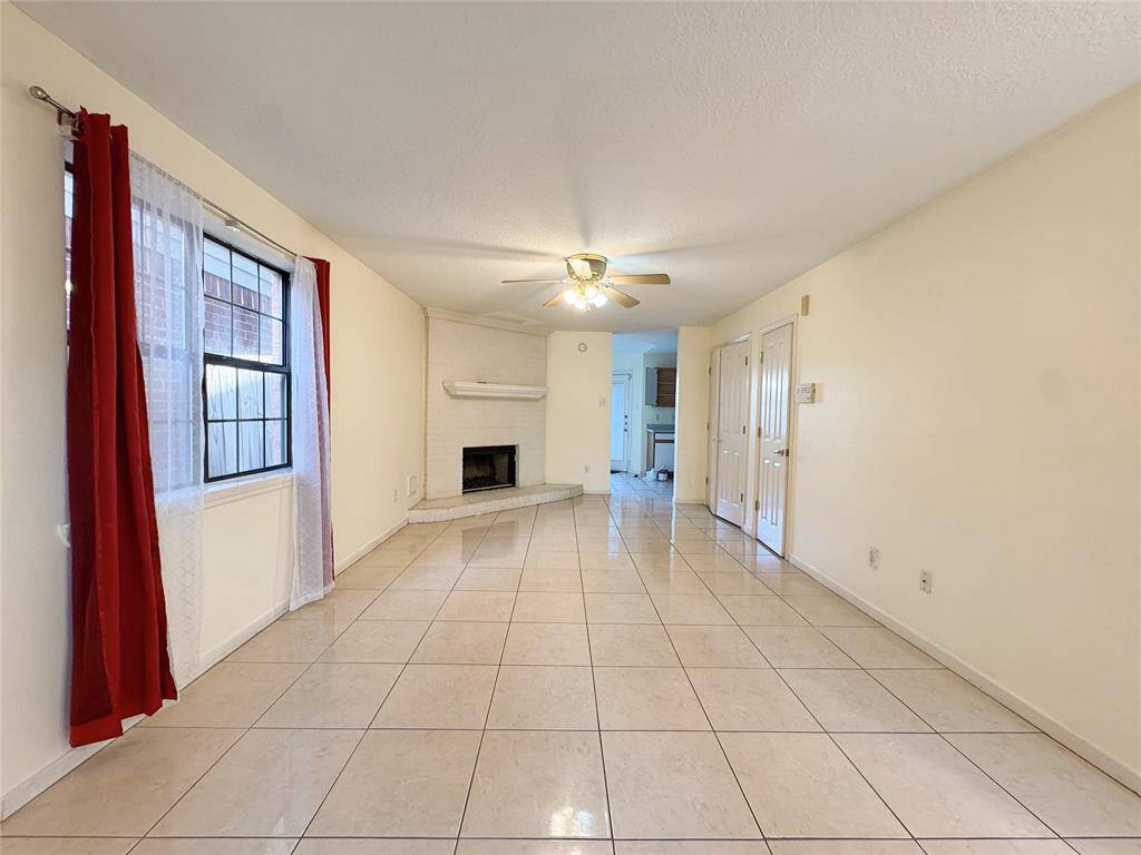 Formal living with fireplace and tile floor