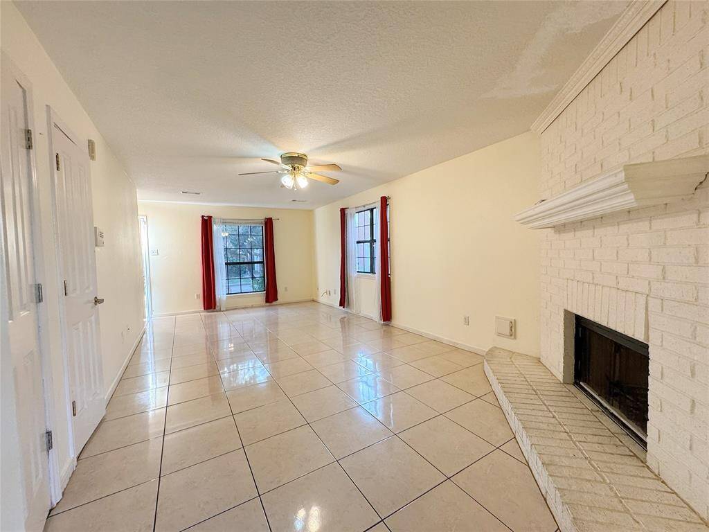 Living room with fireplace and tile floor
