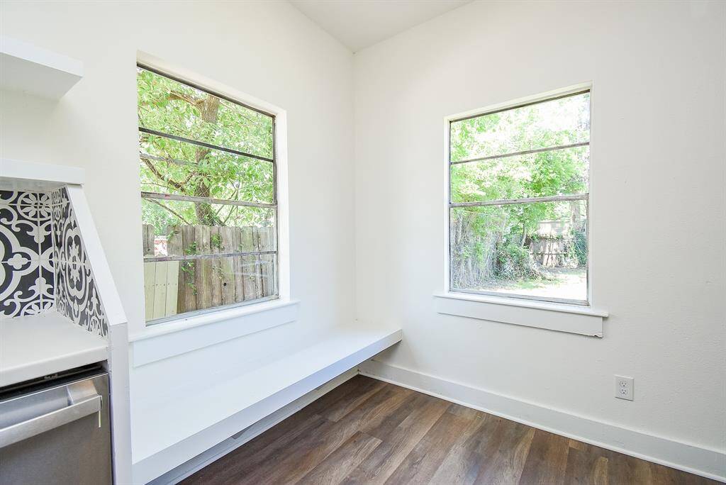 Savor your morning coffee in the inviting breakfast area, featuring a cozy built-in bench surrounded by windows that let in natural light.